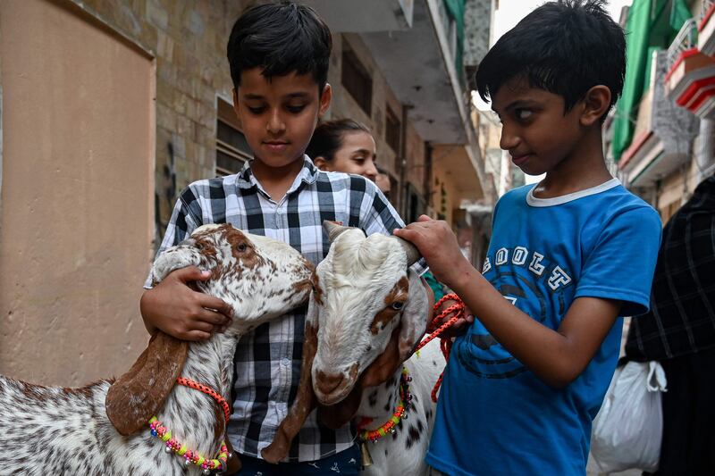 Children with goats in a street in Rawalpindi, northern Pakistan, ahead of Eid Al Adha. AFP