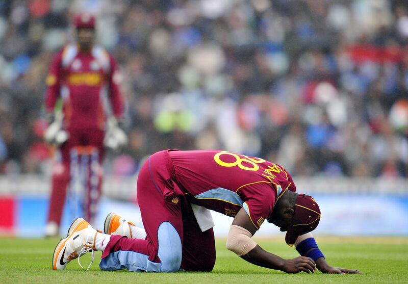 West Indies' Darren Sammy gestures after missing a catch during the 2013 ICC Champions Trophy One Day International (ODI) cricket match between India and West Indies at The Oval in London, England on June 11, 2013.  Light rain stopped play in the Champions Trophy group B match between India and the West Indies at the Oval in London.  India, chasing West Indies' innings score of 233 runs for the loss of seven wickets, were at 204 runs for the loss of two wickets in 35.1 overs at the interruption with Shikhar Dhawan on 92 runs and Dinesh Karthik on 29 runs.  AFP PHOTO/GLYN KIRK - RESTRICTED TO EDITORIAL USE
 *** Local Caption ***  319316-01-08.jpg