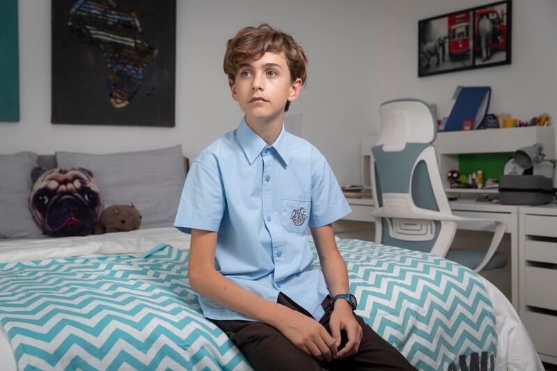 Oliver Wright, 13, a young teenager who wants to work, can now apply for a special new visa that allows over-15s to work in the UAE. Oliver is pictured in his room at his home in Dubai. Antonie Robertson / The National