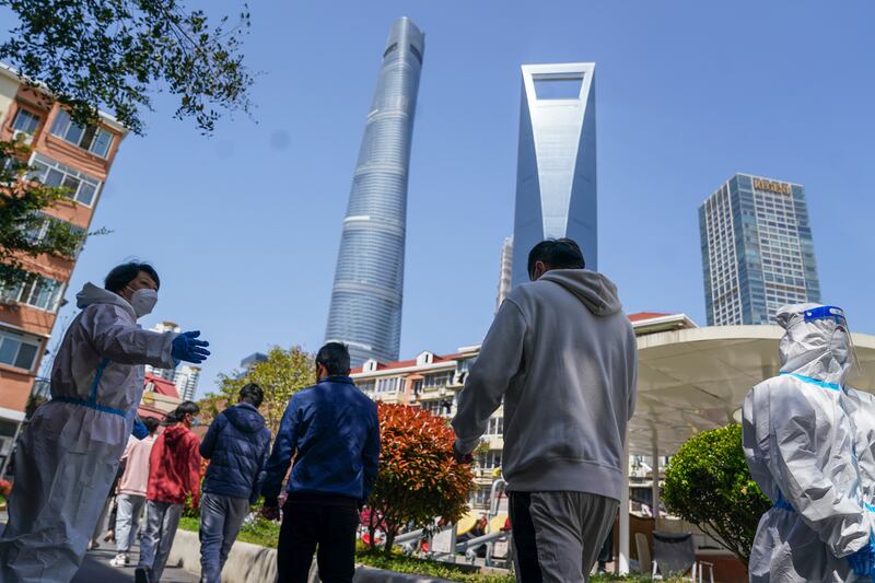 Residents wait to submit samples for tests at a community centre in the Pudong New Area of Shanghai. AP