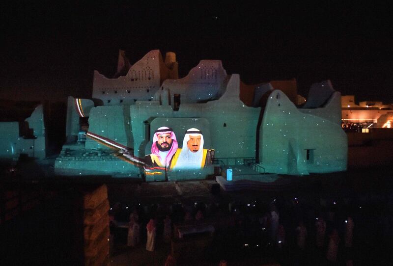 A picture of Saudi King Salman bin Abdulaziz (R) and his son Crown Prince Mohammed bin Salman is projected at the historic site of al-Tarif in Diriyah district, on the outskirts of Saudi capital Riyadh. Saudi Arabia hosts the G20 summit on November 21 in a first for an Arab nation, with the downsized virtual forum dominated by efforts to tackle a resurgent coronavirus pandemic and crippling economic crisis. AFP