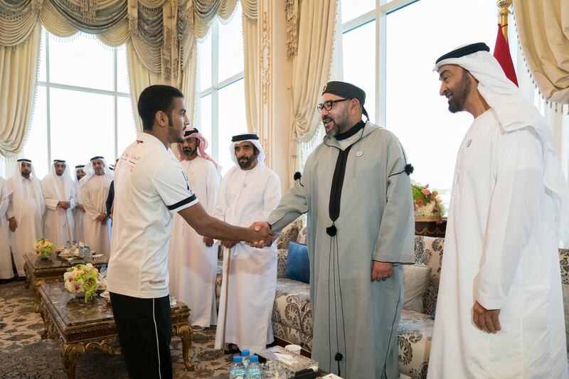 ABU DHABI, UNITED ARAB EMIRATES - September 10, 2018: HM King Mohamed VI of Morocco (2nd R), receives 18th Asian Games Jiu Jitsu winners, during a Sea Palace barza. Seen with HH Sheikh Mohamed bin Zayed Al Nahyan, Crown Prince of Abu Dhabi and Deputy Supreme Commander of the UAE Armed Forces (R) and HH Sheikh Saif bin Mohamed Al Nahyan (3rd R).

( Mohamed Al Hammadi / Crown Prince Court - Abu Dhabi )
---