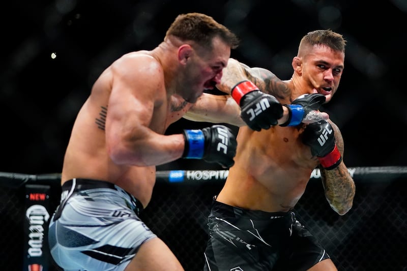 Dustin Poirier punches Michael Chandler during the first round of their lightweight bout at UFC 281. AP