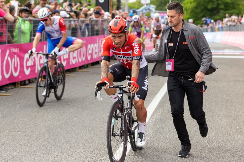 Caleb Ewan is assisted as he approaches the finish line after crashing during the first stage of the Giro d'Italia. EPA