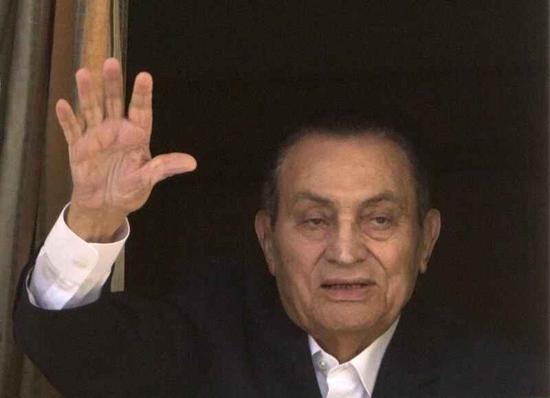 Former Egyptian president Hosni Mubarak waves to his supporters from his room at the Maadi Military Hospital on April 25, 2016. Amr Nabil / AP Photo