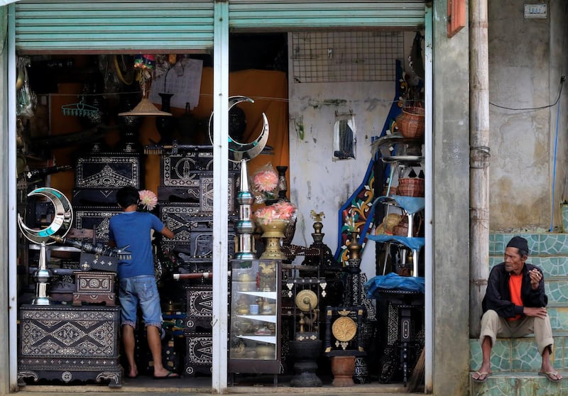 A worker cleans-up displayed antiques for sale inside a store in Marawi city, southern Philippines October 26, 2017. REUTERS/Romeo Ranoco