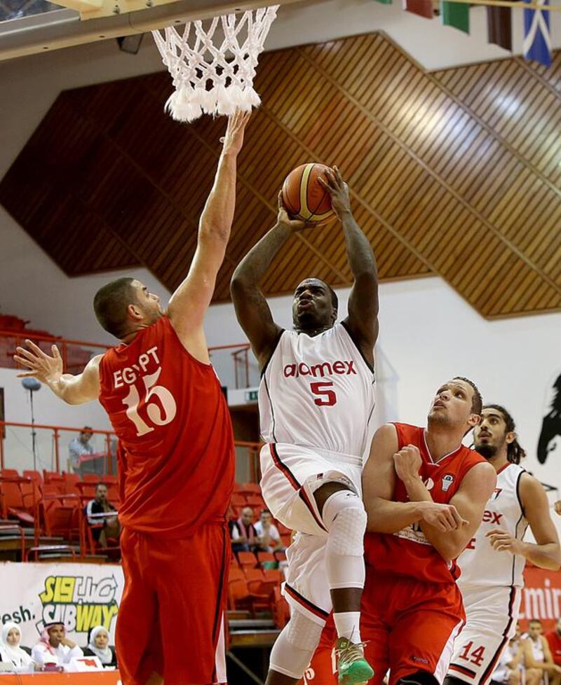 Omar Samhan, 15, of Egypt, goes for a block against Jordanian side Al Riyadi Aramex of Amman. Satish Kumar / The National