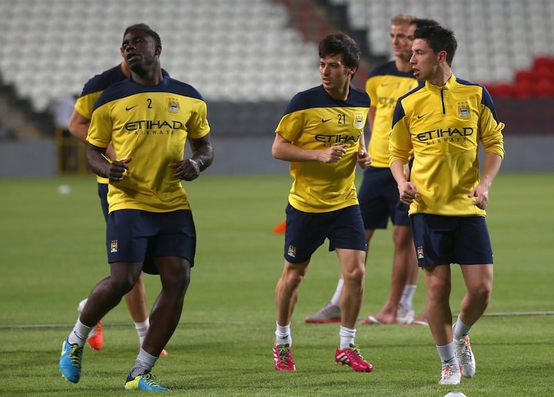 Manchester City players Micah Richards, left, David Silva, centre, and Samir Nasri, right, during a team training session in Abu Dhabi in 2014.