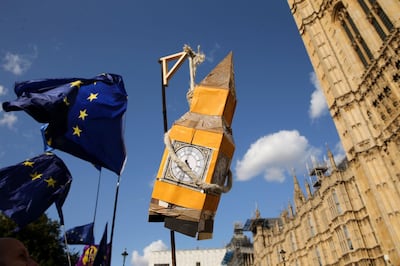TOPSHOT - Activists display a model of Big Ben and EU flags outside the Houses of Parliament in central London on September 4, 2019. Britain's ruling Conservative Party is imploding this week as a result of a no-holds-barred battle over Brexit that has seen the expulsion of 21 moderate MPs, including Winston Churchill's grandson, experts said. / AFP / ISABEL INFANTES
