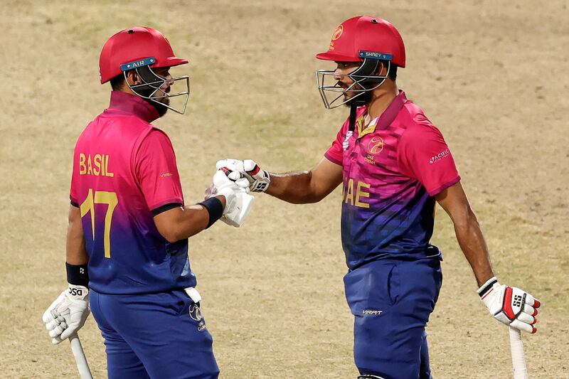 Basil Hameed, left, and CP Rizwan touch gloves during UAE's innings of 148-3. AFP