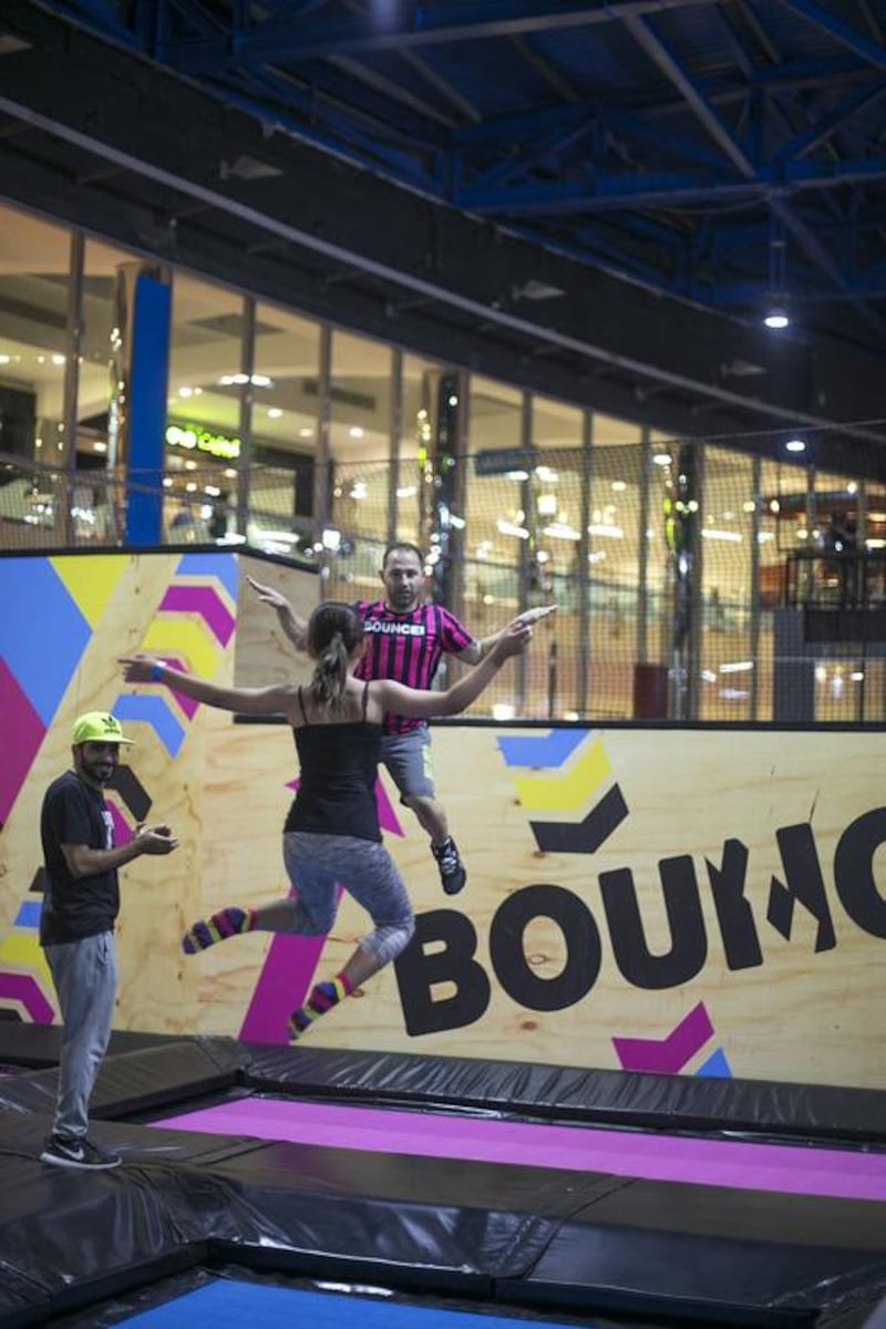 An instructor teaches a visitor some techniques at the opening of Bounce Abu Dhabi in Marina Mall.  Mona Al Marzooqi / The National