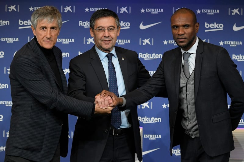 (FILES) In this file photo taken on January 14, 2020 Barcelona's new coach Quique Setien (L) poses with Barcelona's president Josep Maria Bartomeu (C) and football director Eric Abidal during his official presentation in Barcelona after signing his new contract with the Catalan club. Barcelona's football director Eric Abidal was dismissed on August 18, 2020 from his Director of Football position in the Spanish club, one day after Quique Setien was also sacked. / AFP / LLUIS GENE
