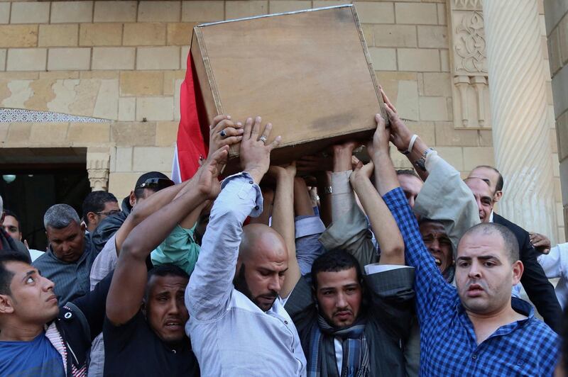People carry the coffin of police captain Ahmed Fayez, who was killed in a gun battle which began Friday, in al-Wahat al-Bahriya area in Giza province, about 135 kilometers (84 miles) southwest of Cairo, during his funeral at Al-Hosary mosque, in Cairo, Egypt, Saturday, Oct. 21, 2017. At least 54 policemen, including 20 officers and 34 conscripts, were killed when a raid on a militant hideout southwest of Cairo escalated into an all-out firefight, authorities said Saturday, in one of the single deadliest attacks by militants against Egyptian security forces in recent years. (AP Photo/Alaa Elkassas)