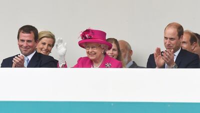LONDON, ENGLAND - JUNE 12: Peter Phillips (L) and Prince William, Duke of Cambridge (R) look on as Queen Elizabeth II waves to guests attending "The Patron's Lunch" celebrations for The Queen's 90th birthday on The Mall on June 12, 2016 in London, England. 10,000 guests have gathered on The Mall for a lunch to celebrate The Queen's Patronage of more than 600 charities and organisations. The lunch is part of a weekend of celebrations marking Queen Elizabeth II's 90th birthday and 63 year reign. The Duke of Edinburgh and other members of The Royal Family are also in attendance. During the lunch a carnival parade will travel down The Mall and around St James's Park.  (Photo by Toby Melville - WPA Pool/Getty Images)