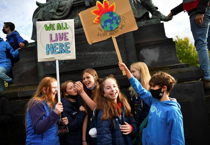 Young people holding placards attend the Fridays for Future march. Reuters
