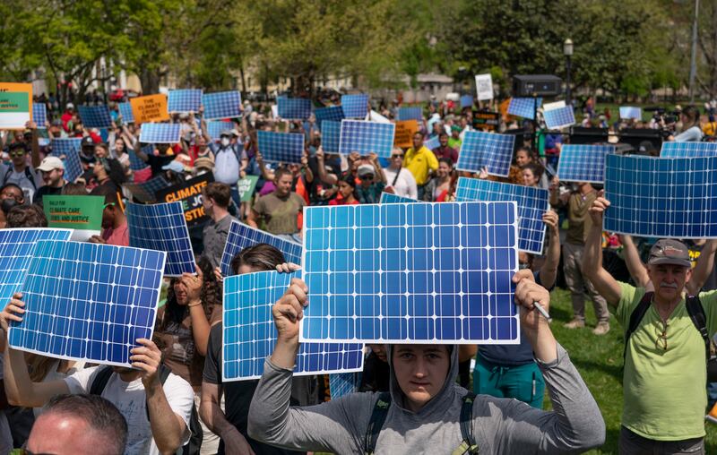 Activists display prints replicating solar panels during a rally to mark Earth Day in Washington. AP Photo