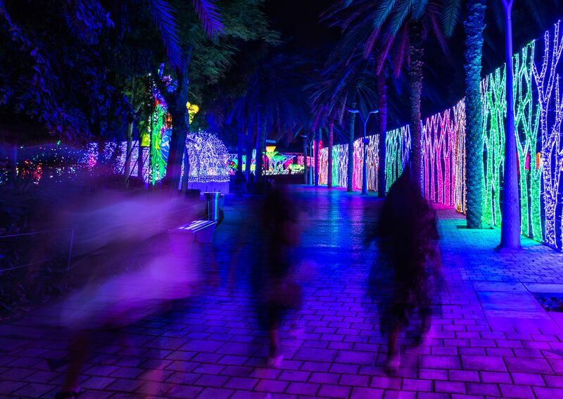 Visitors walk through the brightly-lit attraction