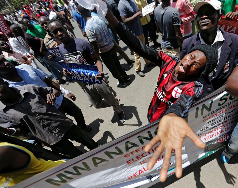Supporters of the opposition National Super Alliance (NASA) coalition, carry banners and react during a protest calling for the sacking of election board officials involved in August's cancelled presidential vote in Nairobi, Kenya. Thomas Mukoya / Reuters