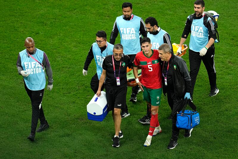 Morocco's Nayef Aguerd walks off the pitch after picking up an injury. AP 