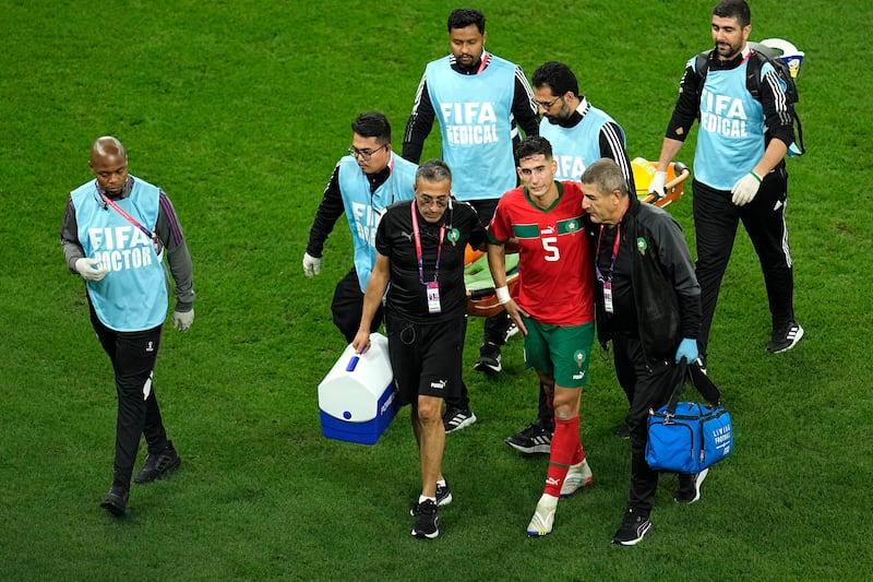 Morocco's Nayef Aguerd walks off the pitch after picking up an injury. AP 