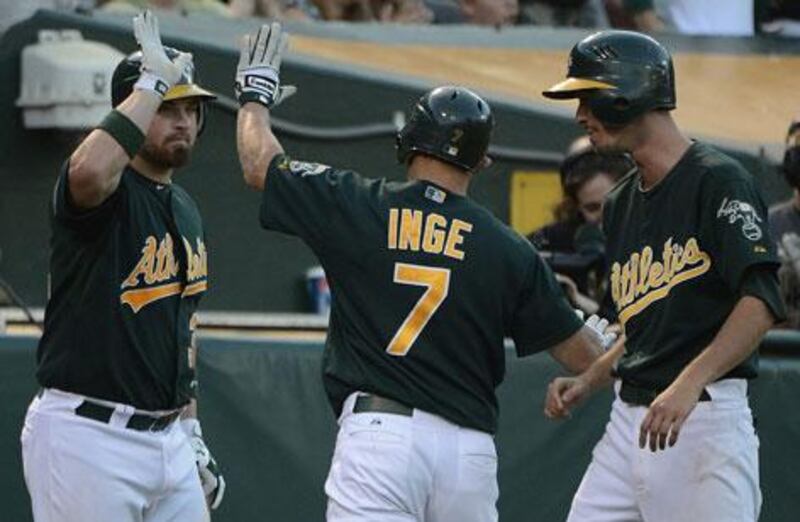 Brandon Inge is congratulated by Derek Norris as Oakland defeat the Yankees