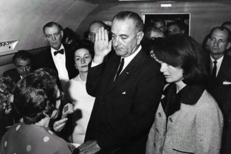 Lyndon B Johnson is sworn in as the 36th president of the United States on board Air Force One, after the assassination of President John F Kennedy. 
His wife, Lady Bird, left, and the grief-stricken first lady, Jackie Kennedy, look on. Keystone / Getty Images