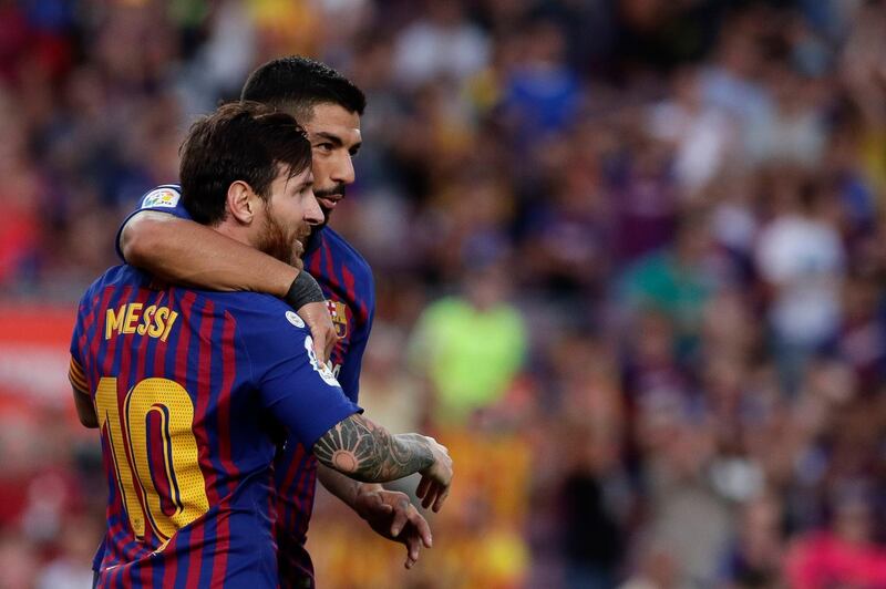 Barcelona's Lionel Messi, front, celebrates with teammate Luis Suarez after scoring his side's sixth goal during a Spanish La Liga soccer match between Barcelona and Huesca at the Camp Nou stadium in Barcelona, Spain, Sunday Sept. 2, 2018. (AP Photo/Eric Alonso)