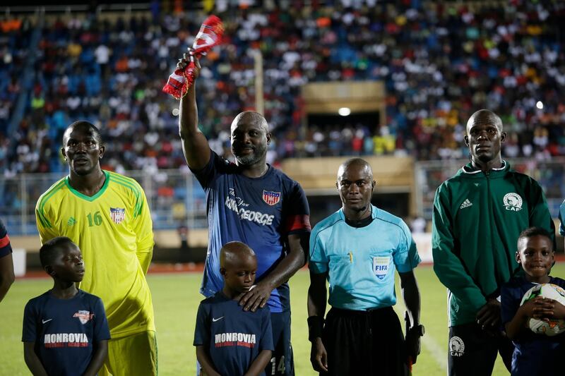 George Weah waves to fans prior to the kick off. EPA