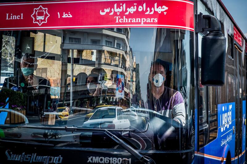 A public bus driver wears a protective face mask while working in central Tehran, March 15. Bloomberg