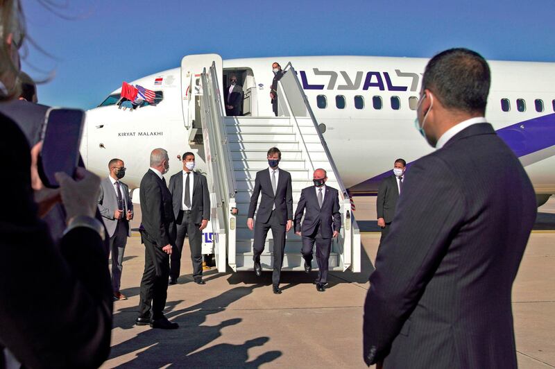 A handout picture released by the US Embassy in Morocco, shows US Presidential advisor Jared Kushner (L) and Israeli National Security Advisor Meir Ben Shabbat leaving the airplane in Morocco's capital Rabat, upon landing of the first Israel-Morocco direct commercial flight, marking the latest US-brokered diplomatic normalisation deal between the Jewish state and an Arab country.  AFP