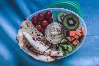 Deconstructed lunchbox sandwich, featuring hummus, flat breads and raw vegetables