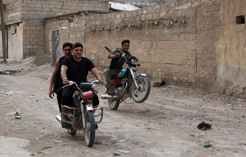 Turkey-backed Syrian fighters ride motorcycles in Ras Al Ain.  Turkey's President Recep Tayyip Erdogan fired off a fresh warning today to "crush" Kurdish forces as both sides traded accusations of violating a US-brokered truce deal in northeastern Syria.  AFP