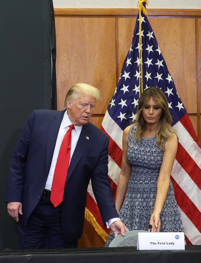 US President Donald Trump helps first lady Melania Trump with her seat while attending a SpaceX mission briefing at the Kennedy Space Centre in Cape Canaveral. Reuters