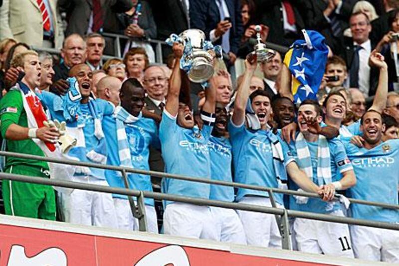 Manchester City's players pose with the trophy.