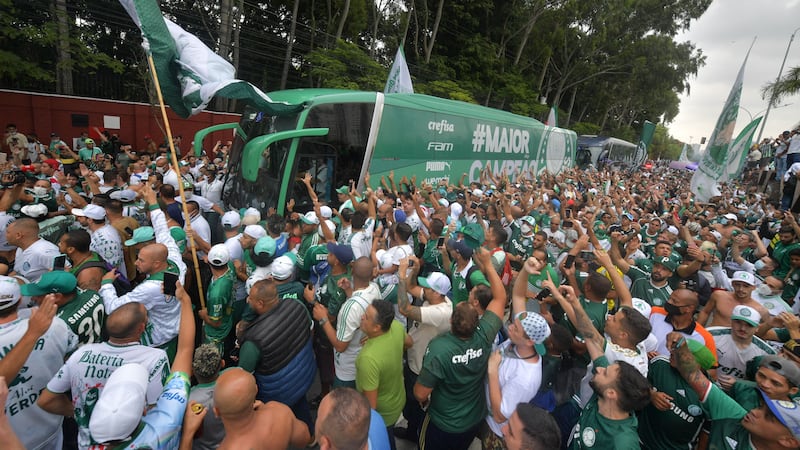 Supporters of Brazilian football club Palmeiras surround a bus taking its players to the airport in Sao Paulo, from where they will fly to Abu Dhabi to play in the FIFA Club World Cup. AFP