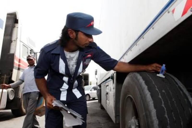 Dubai, 5th August 2010.  Hamad Ismael Essa Hassan Al Bedwawi (Inspector-Maintenance and Enforcement of RTA) is seen checking the truck tyre with a depth gauge, which measures the tyre thread if within acceptable thickness. During the tyre safety campaign, at the Fruits and Vegetables Market.  (Jeffrey E Biteng / The National)    