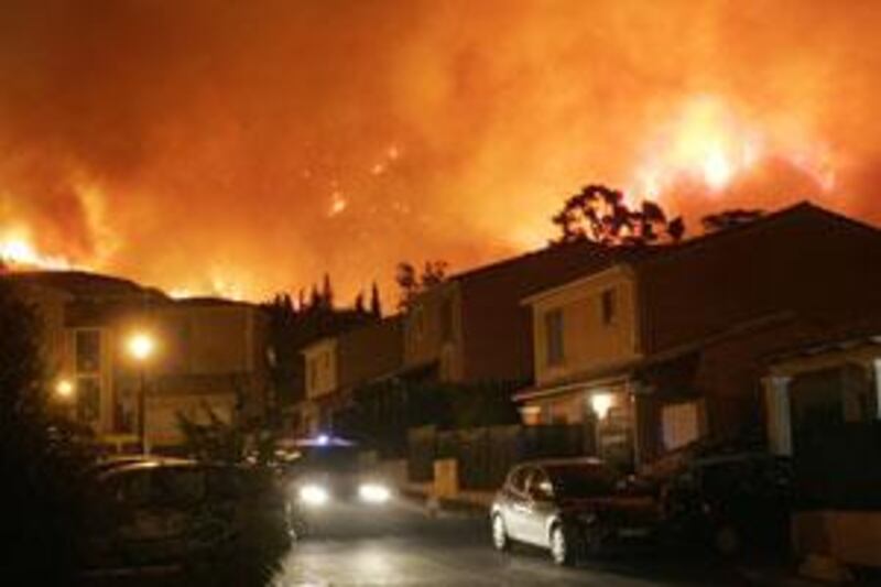 A bush fire threatens residences in the southern French city of Marseille, on July 23 2009. More than 300 people were evacuated from their homes fires started by a military exercise neared the city.