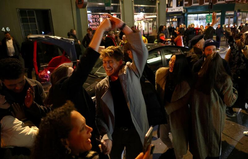 People gather on a street in Soho. Reuters