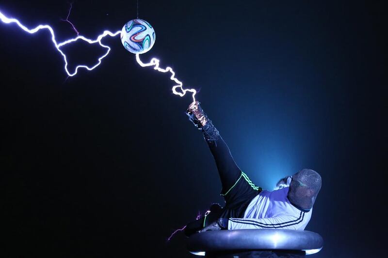 Chinese performance group LightningFan group member Wang Hongbin performing with a football as he creates lightning with a Tesla Coil in Changle, in eastern China's Fujian province. Chinese performance group LightningFan group member Wang Hongbin performing with a football as he creates lightning with a Tesla Coil. Wang Hongxin / AFP / LightningFan
