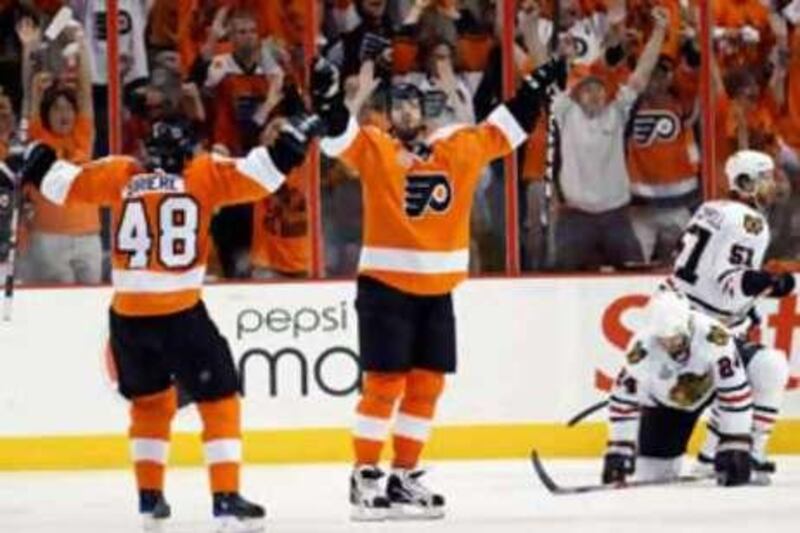 The Flyers left wing Ville Leino, centre, celebrates with Danny Briere (48) after scoring against the Blackhawks in the third period.