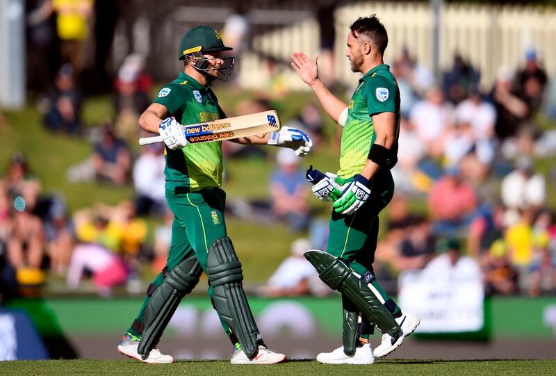 South Africa's batsmen David Miller (L) and Faf du Plessis (R) celebrate scoring their centuries against Australia during the third one-day international cricket match in Hobart on November 11, 2018. / AFP / WILLIAM WEST
