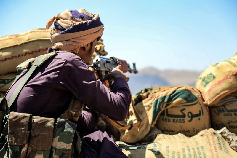 A fighter loyal to Yemen's Saudi Arabia-backed government guards a position near the frontline facing Houthi rebels in the country's north-east province of Marib, on October 17, 2021. AFP