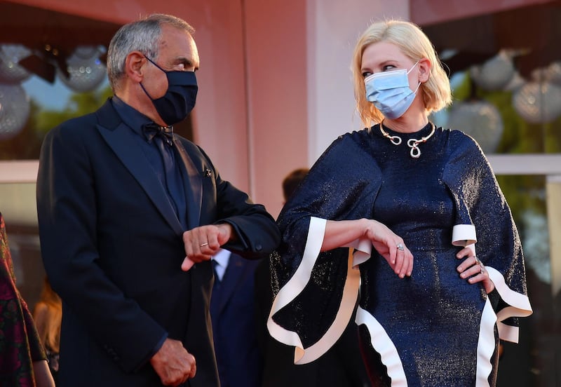 Festival director Alberto Barbera and Cate Blanchett touch elbows as they arrive for the Opening Ceremony. EPA