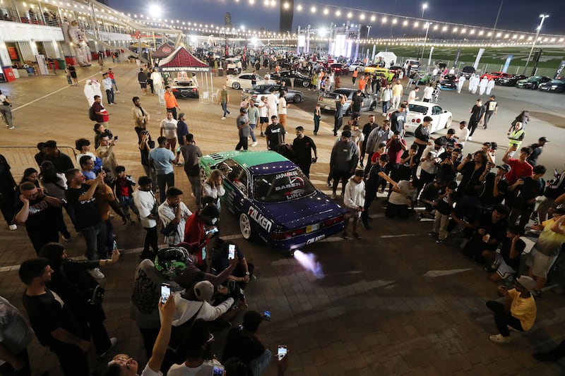 Visitors surround a Toyota Mark II at the Kandura Rally x Hot Wheels car show. Motor City, Dubai. Chris Whiteoak / The National