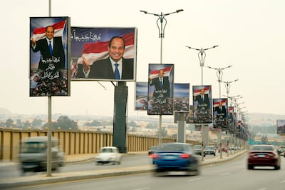 Billboards of Egyptian President Abdel Fattah El Sisi, who revealed details of state support on Thursday. AP