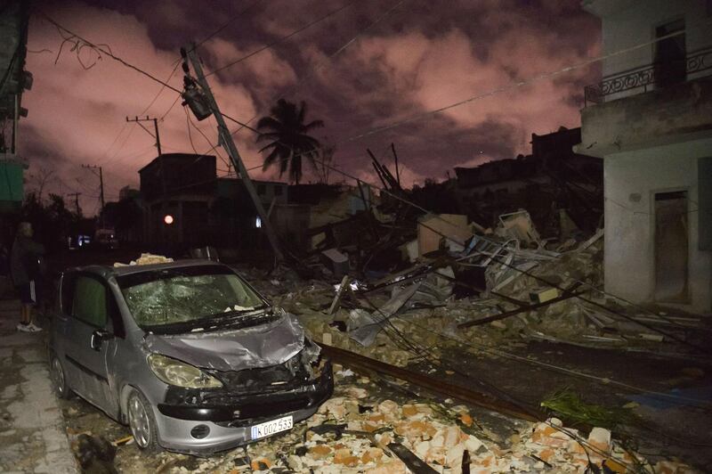 A damaged car is seen among building rubble in the tornado-hit Luyano neighbourhood in Havana early on January 28, 2019. 
AFP