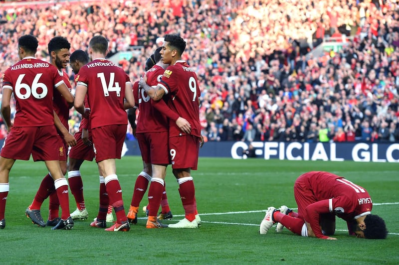 Liverpool's Mohamed Salah celebrates scoring his side's second goal of the game during the English Premier League soccer match between Liverpool and Bournemouth at Anfield, Liverpool, England. Saturday April 14, 2018. (Anthony Devlin/PA via AP)