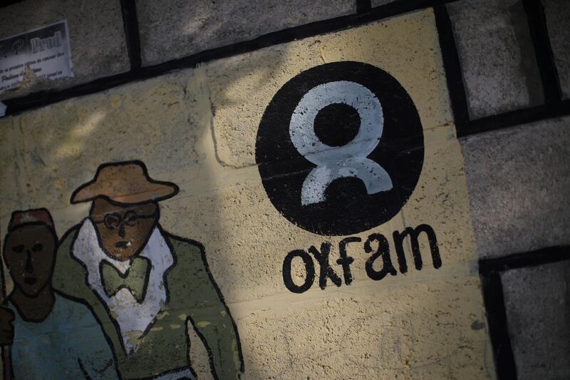 An Oxfam sign is seen on a wall in Corail, a camp for displaced people of the earthquake of 2010, on the outskirts of Port-au-Prince, Haiti, February 17, 2018. REUTERS/Andres Martinez Casares