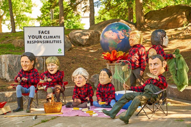 Oxfam activists wear masks of G7 leaders as they protest during the G7 Summit in Quebec City, Canada. Andre Pichette / EPA