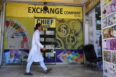 A man walks past a currency exchange shop in Islamabad. Pakistan's desperately low foreign exchange reserves were boosted on July 11 with a $2 billion deposit from Saudi Arabia, ahead of a key IMF meeting to approve a standby deal. AFP